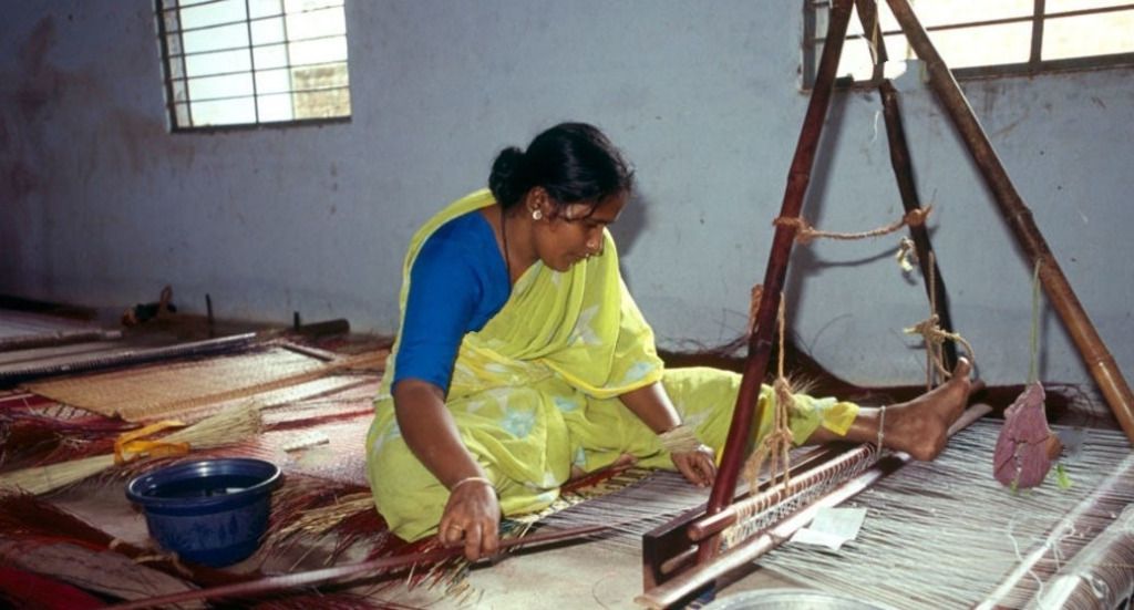 An artisan handcrafting a mat using Pattamadai Pai method