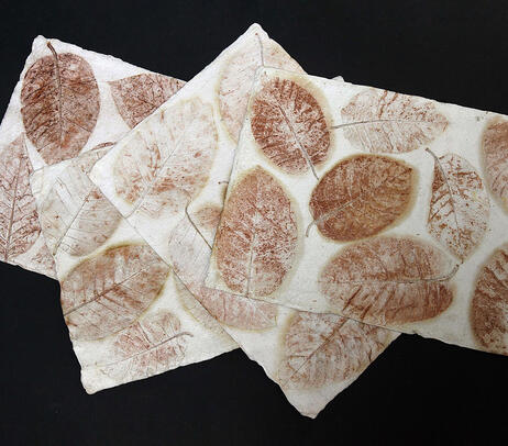 Handmade cotton paper table mats with leaf imprints