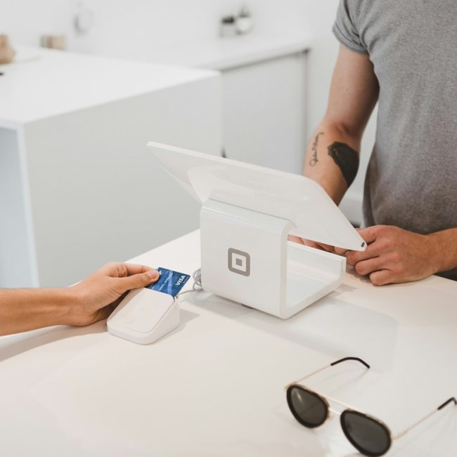 A customer making payment at checkout through POS system