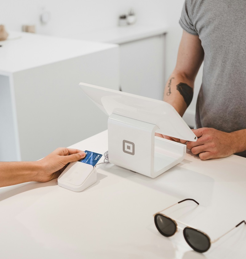 A customer making payment at checkout through POS system