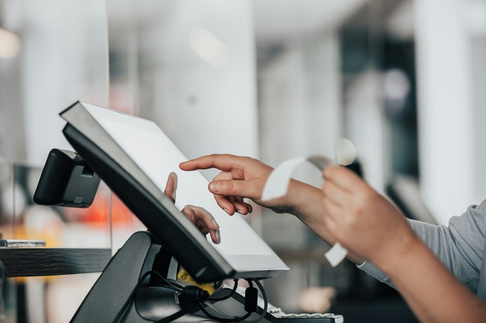 An employee making an entry on the POS system