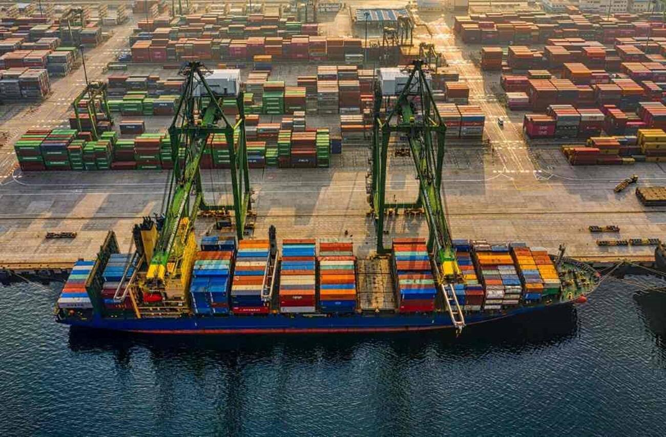 A ship with containers docked at a port