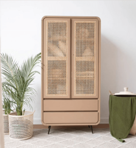 Minimalistic decor setup of a rattan wardrobe, hamper, and planters